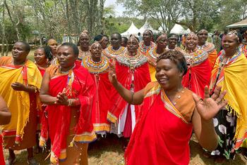 Kenyans celebrate following the signing of commitments by councils of elders to end female genital mutilation in the Samburu and Mount Elgon regions.
