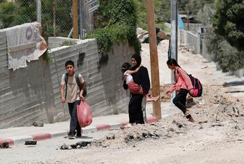 Members of a family flee Jenin due to an escalation of violence.