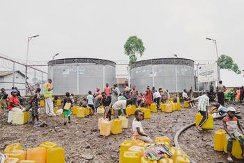 People displaced by conflict collect water from reservoirs installed by UNICEF at a camp near Goma in the DR Congo.